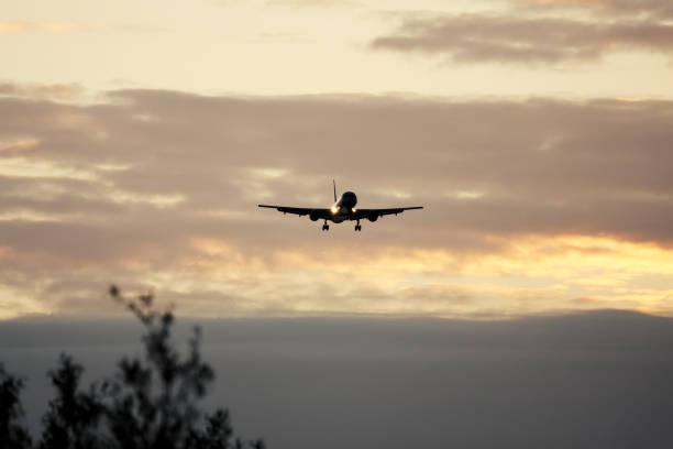 istock air plane in sunset sky 1178511898