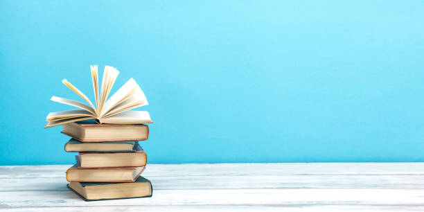 istock Open book, hardback books on wooden table. Back to school. Copy space 1178512103