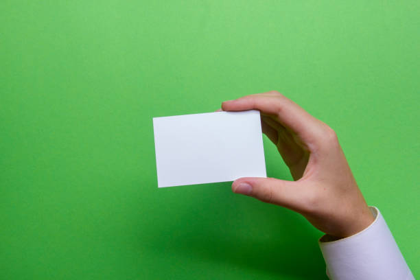 istock Hand holding white business card on white background 1178512679