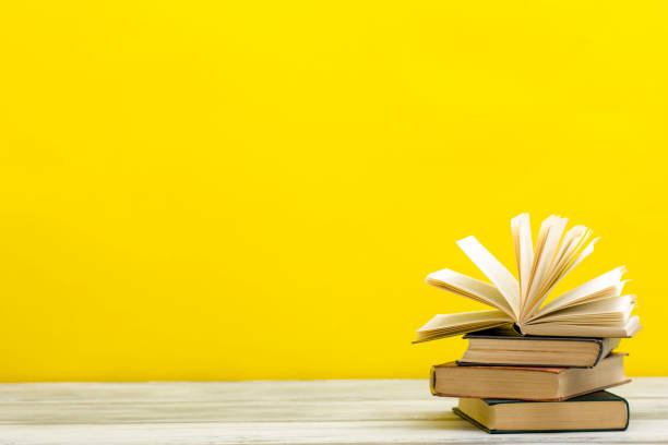istock Open book, hardback books on wooden table. Back to school. Copy space 1178512689