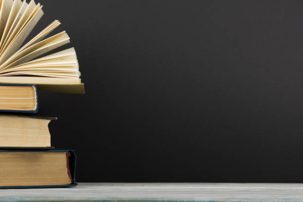 istock Open book, hardback books on wooden table. Back to school. Copy space 1178512768
