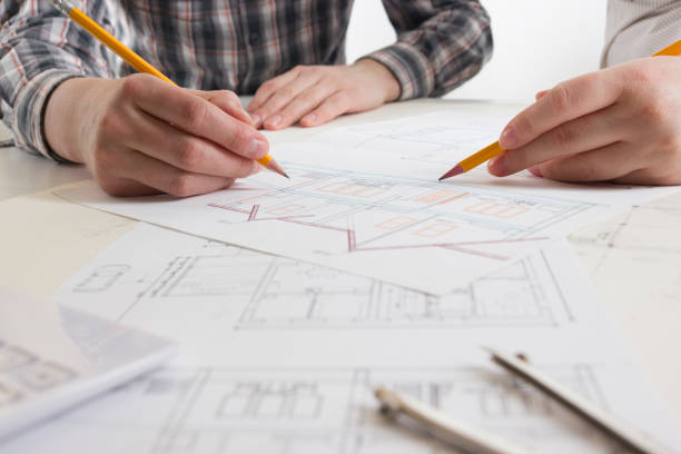 architects working on blueprint, real estate project. architect workplace - architectural project, blueprints, ruler, calculator, laptop and divider compass. construction concept. engineering tools. - housing project organization meeting real estate imagens e fotografias de stock