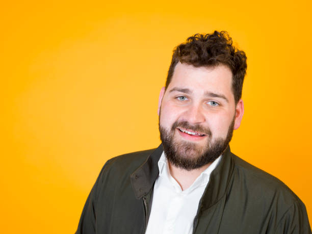 istock cool man posing in front of orange background 1178513287