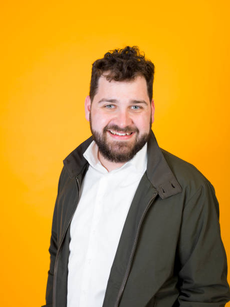 istock cool man posing in front of orange background 1178513307