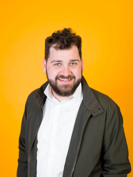 istock cool man posing in front of orange background 1178513421