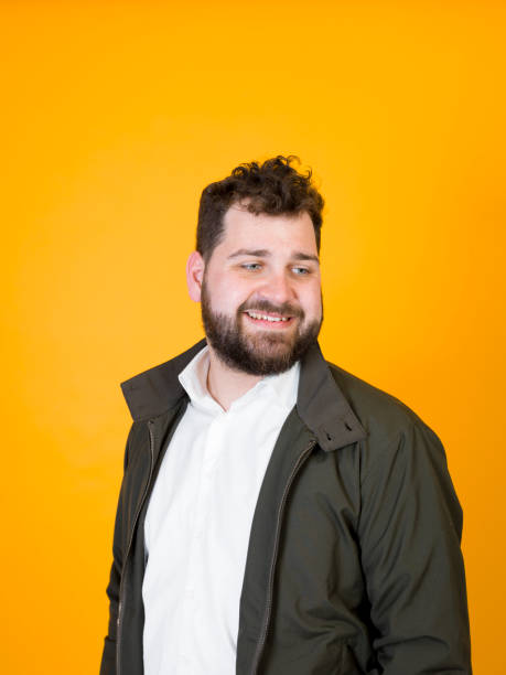 istock cool man posing in front of orange background 1178513766