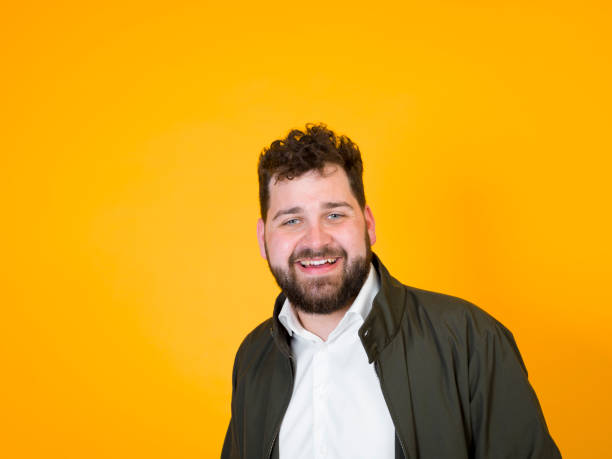 istock cool man posing in front of orange background 1178513838