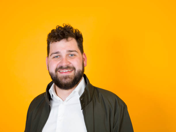 istock cool man posing in front of orange background 1178514443