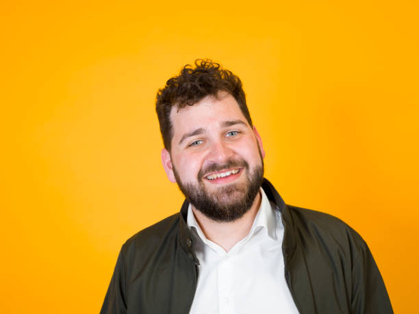 istock cool man posing in front of orange background 1178514482