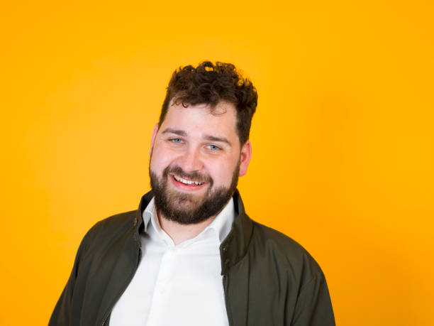 istock cool man posing in front of orange background 1178514548