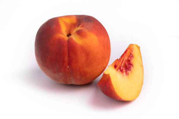 istock Side view on a composition of one whole peach and a slice of it 1178514806