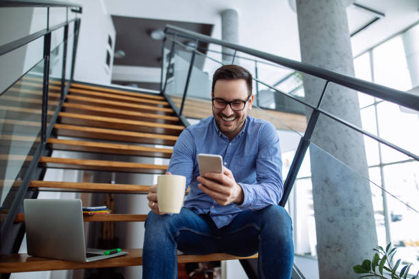 istock Businessman sitting on the stairs and text messaging 1178515249