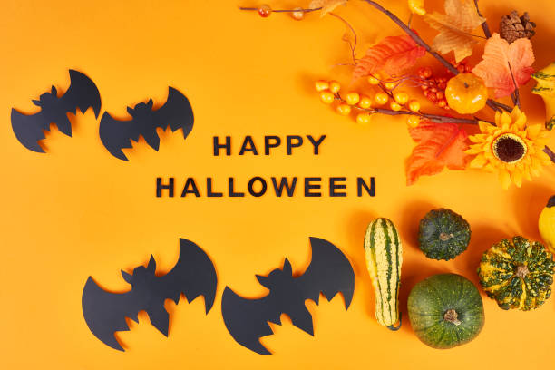 istock Halloween greeting card with bats and pumpkins 1178516474