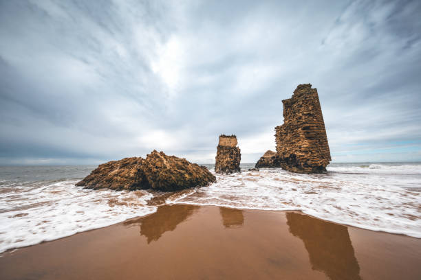 Ruins of Torre del Rio De Oro on the beach in Mazagon, the province of Huelva, Andalusia, Spain.
