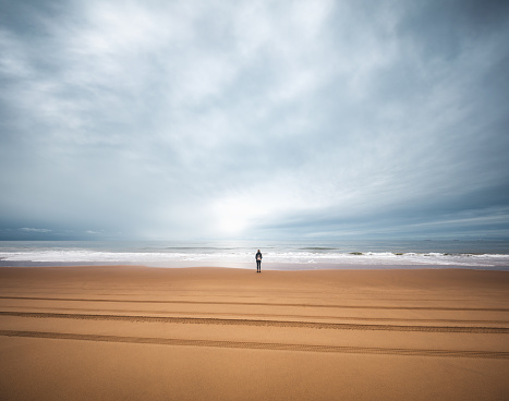Woman standing on the beach in Mazagon, the province of Huelva, Andalusia, Spain.