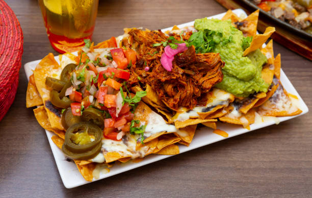 istock Corn chips nachos with homemade guacamole sauce, meat, cheese 1178517895
