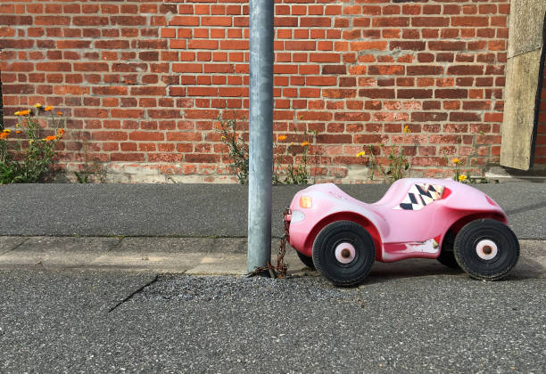 A child toy car parked at a lantern