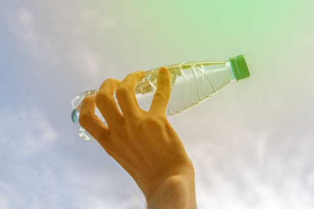 istock hand holding a plastic bottle with pure water against the sky 1178518055