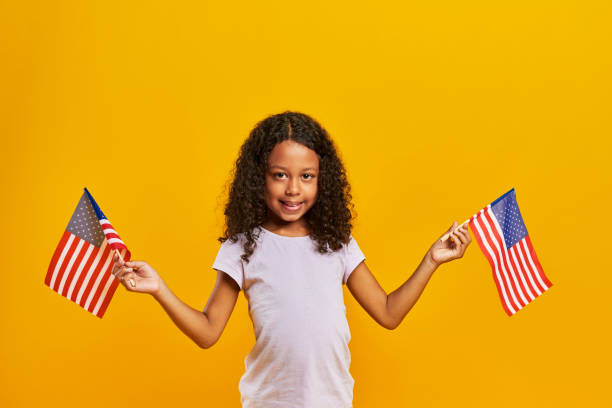 istock African girl waving American flags 1178519011