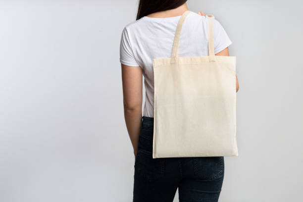 istock Girl Holding Eco Bag Standing Back To Camera On White 1178519014
