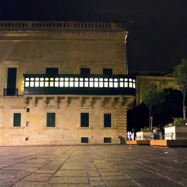 Illuminated Gallarija of Grandmaster's Palace in Valletta, in a rainy evening