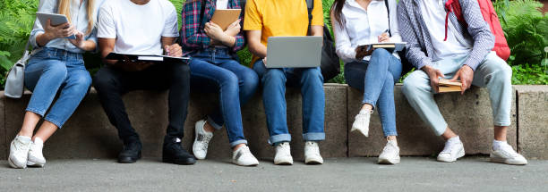 istock Students using laptop and books, preparing for lectures outdoors 1178519193