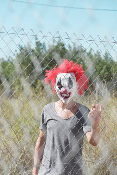 istock scary clown behind a fence 1178519762