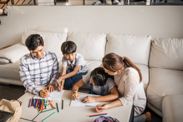 istock Parents doing homework with daughter and son 1178520728
