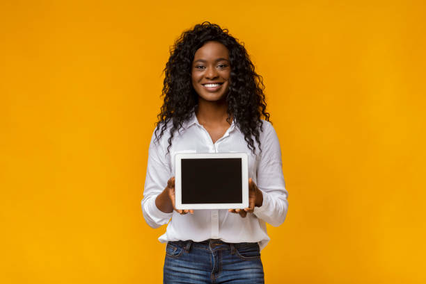 istock Smiling african woman demonstrating blank digital tablet screen 1178522361