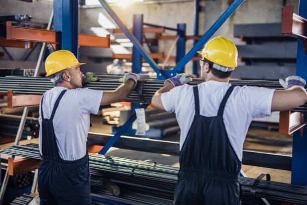 istock Rear view of manual workers cooperating while working with metal in aluminum mill. 1178523048