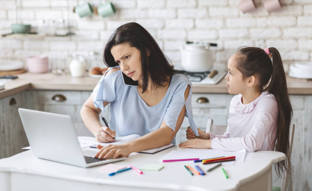 istock Little girl trying to get mother's attention while she working 1178523763
