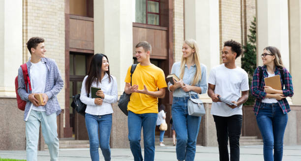 istock Multiracial students walking against university building during break 1178523874