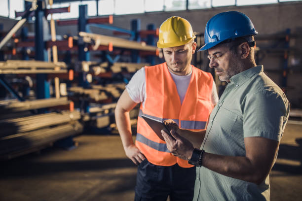istock Mid adult inspector and metal worker analyzing work plan on touchpad in a factory. 1178523951