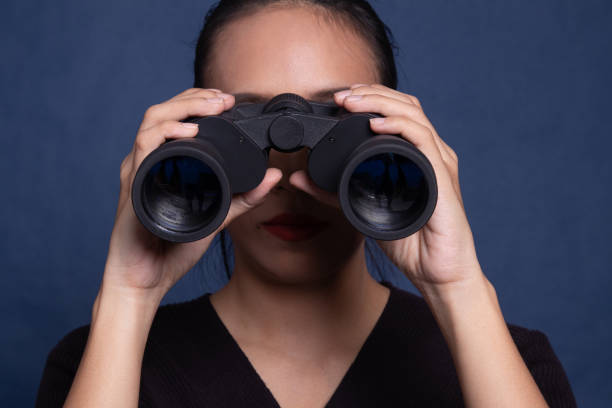 istock Young Asian woman with binoculars. 1178524007