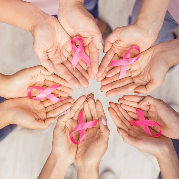 istock Female Hands Joined In Circle Holding Pink Ribbons, White Background 1178524116
