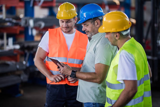 istock Manager and manual workers using digital tablet in industrial building. 1178524137