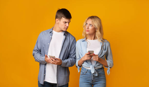 istock Jealous guy looking at girlfriend's cellphone, reading her messages 1178525760