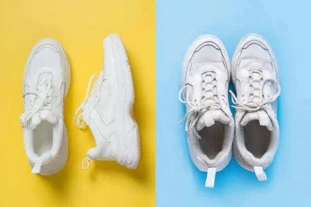 Photo of Pair of white female sneakers on yellow and old shoes on blue. Flat lay, top view minimal background.