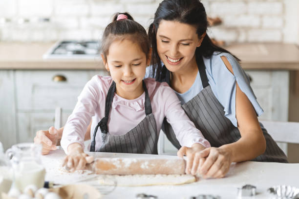 istock Happy family rolling out the dough for pie together 1178526770