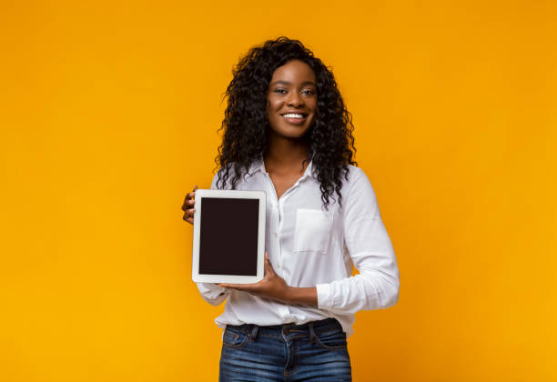 istock Cheerful black woman demonstrating blank digital tablet screen 1178527404