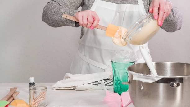 istock Mixing royal icing to decorate Easter sugar cookeis 1178528069