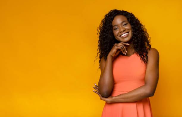 istock Shy smiling african woman touching her neck 1178528462