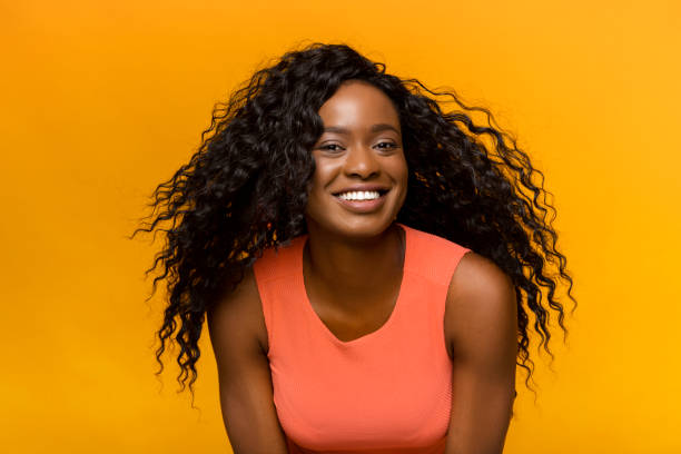 istock Attractive african girl posing at camera over yellow background 1178528520