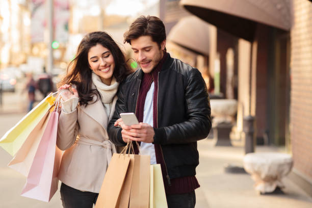 istock Young couple searching new boutique, using smartphone 1178528559