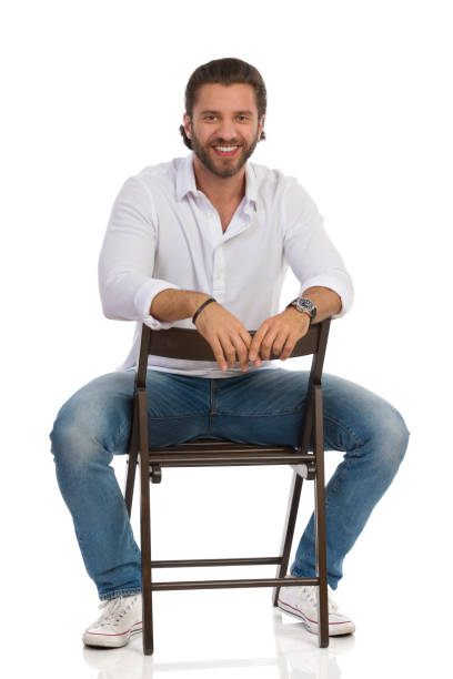 istock Handsome Man Is Sitting On A Chair, Looking At Camera And Smiling. 1178528674