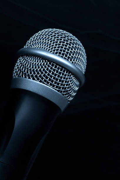 istock Close-up black microphone head isolated on black background. 1178528679