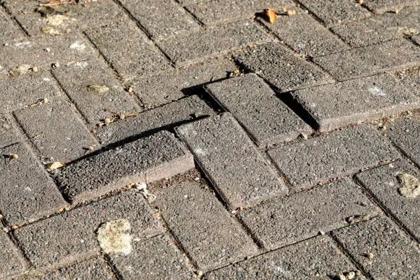 Photo of Stone pavers heave to give uneven surface