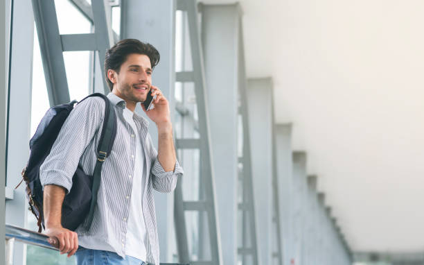 istock Young man traveller talking on mobile phone in airport 1178528801