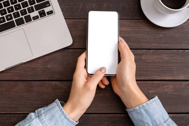 istock Woman's hand holding and touching blank mobile phone screen 1178528859