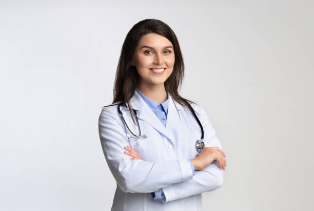 istock Smiling Female Doctor Standing Crossing Hands Over White Background 1178529651